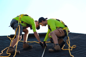 Two individuals inspecting a roof