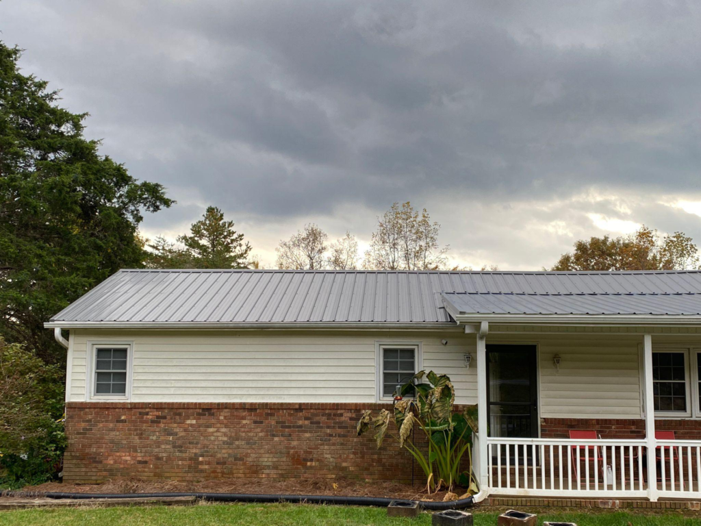 A photo showing a home with a grey metal roof