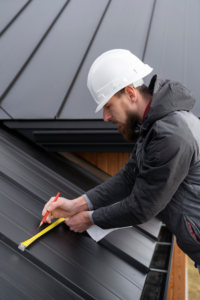 A man working on a roof, using tools for roofing tasks