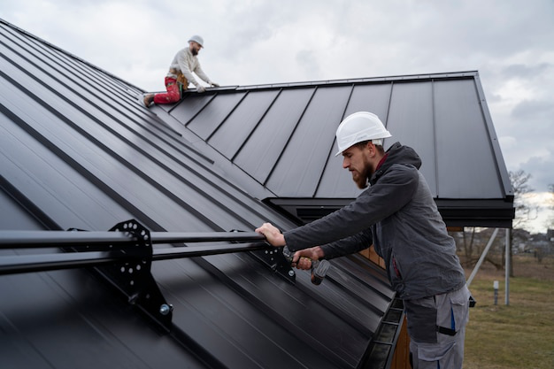 Two men working together on a roof