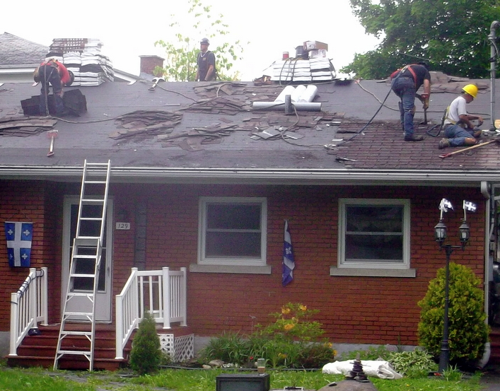 Roofing contractors working on a roof