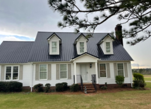 A photo showing a home with a black roof