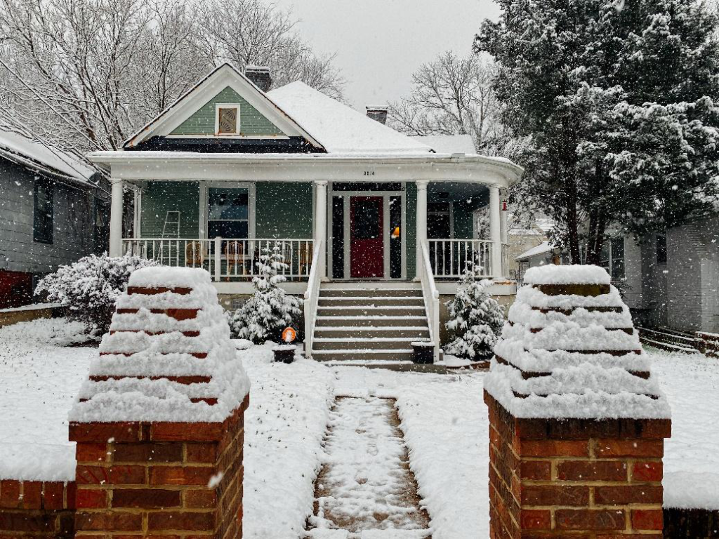 View of a property covered in snow