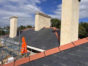 A roof and chimneys being repaired