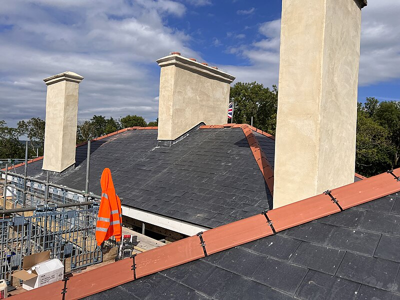 A roof and chimneys being repaired