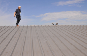 A roofing contractor inspecting a roof