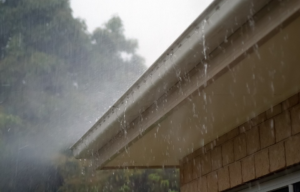 Water falling from a roof and through the gutter