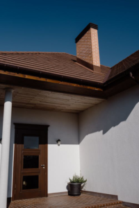 A single-story house with a chimney on the roof, highlighting the importance of chimney maintenance and leak repair to prevent water damage.