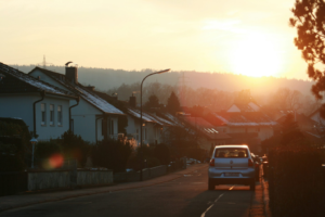 Charming houses lit by golden hour sunlight, emphasizing well-maintained chimneys and roofing for lasting durability.