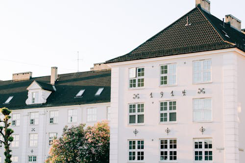 A multi-story house with a chimney on the roof, showcasing the need for professional chimney repair to prevent water damage and maintain structural safety.