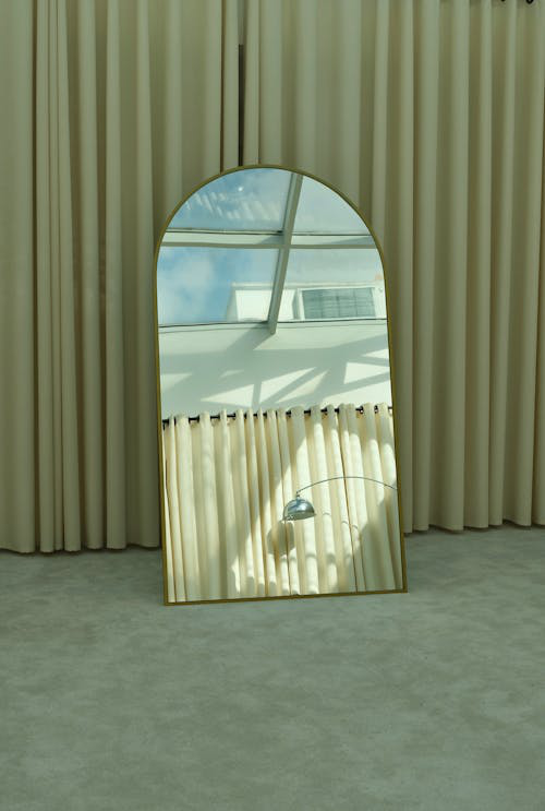 A mirror reflecting the light from a skylight creating a bright and airy atmosphere in the room.