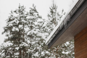 Snow-covered gutter demonstrating the importance of gutters in protecting homes during winter.