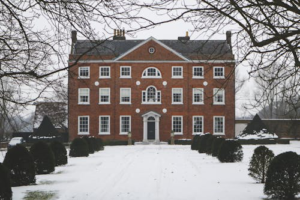 A well-maintained house with chimneys, showcasing the importance of professional chimney contractors in New York.