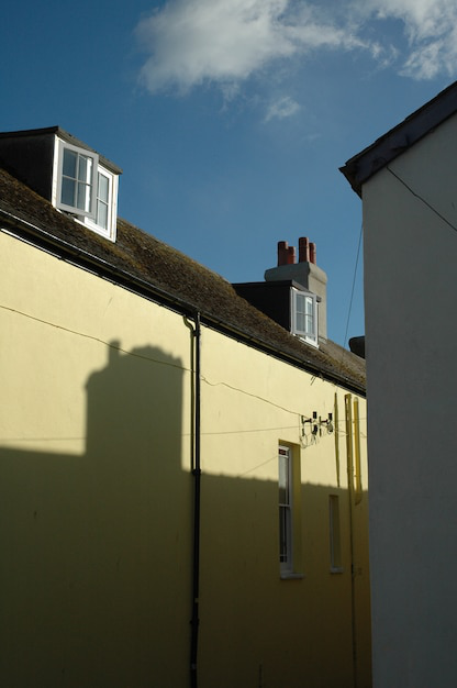 A seamless gutter system along the side of a building, directing rainwater away from the roof.