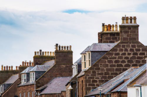 A row of houses with chimneys standing tall, symbolizing protection against weather damage