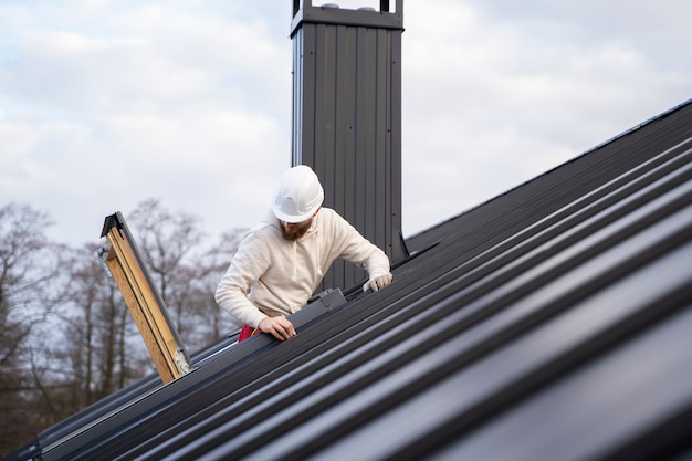 A professional installer securing a new skylight on a residential roof, ensuring proper fit and weatherproofing.