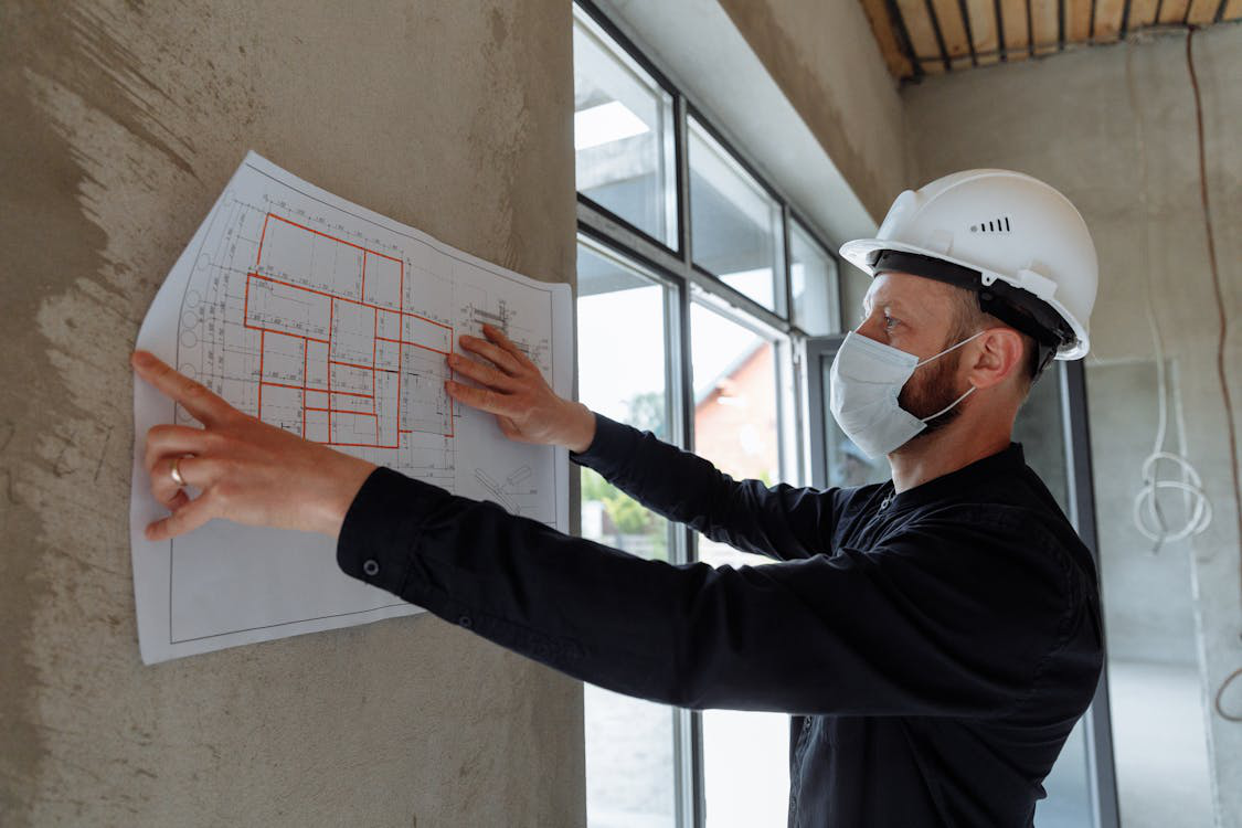 A contractor examining the layout of a building